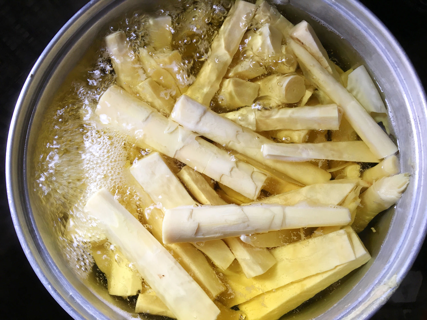 Small bamboo shoots boiling in a pot of water